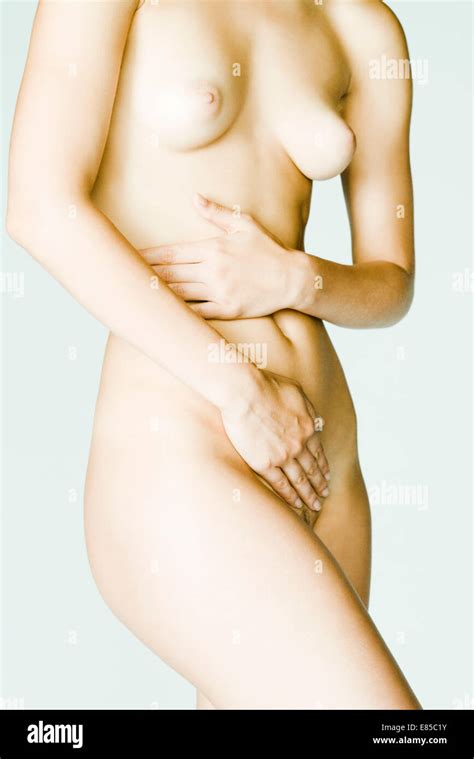 Nude Woman Covering Body With Hands Mid Section Stock Photo Alamy