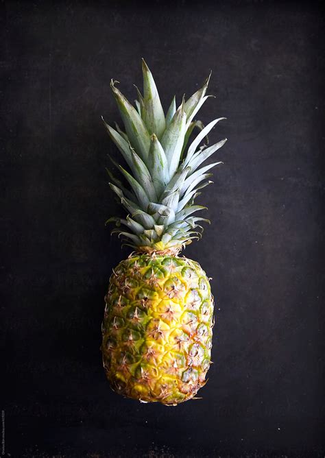 "Pineapple On Simple Black Background" by Stocksy Contributor "Orsolya Bán" - Stocksy