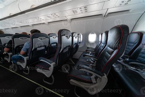 Airplane cabin seats with passengers. Economy class of new cheapest low