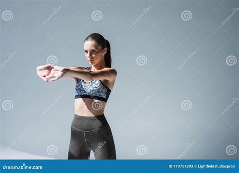 Attractive Young Sporty Woman Stretching Hands Before Training Stock