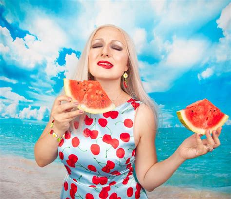 Charming Plump Blonde In Blue Pin Up Dress Stands With A Piece Of