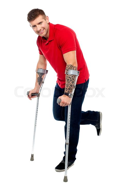 Walking with help of crutches and smiling | Stock image | Colourbox