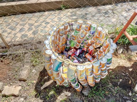 A recycling bin made from recycled soda cans to collect soda cans for ...