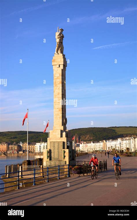 Cyclists on Douglas Promenade with War Memorial, Douglas, Isle of Man ...