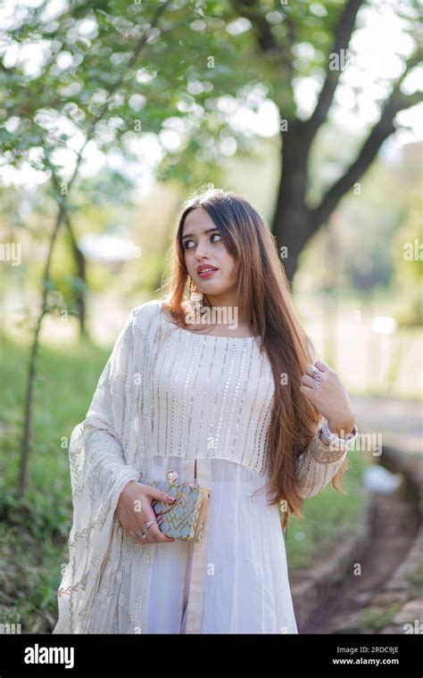 Beautiful Asian Girl Posing In Front Of Trees And Giving Pose The