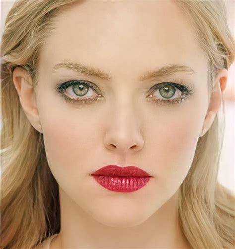 A Woman With Long Blonde Hair And Green Eyes Is Wearing Red Lipstick On