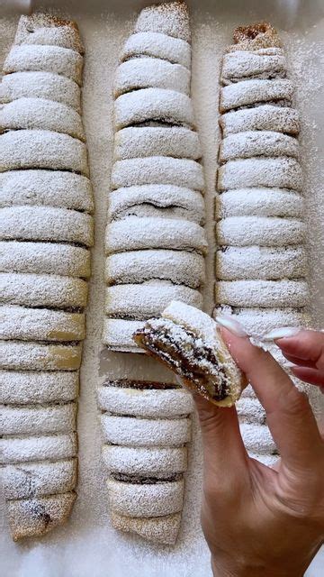 A Person Is Holding A Powdered Pastry In Their Hand