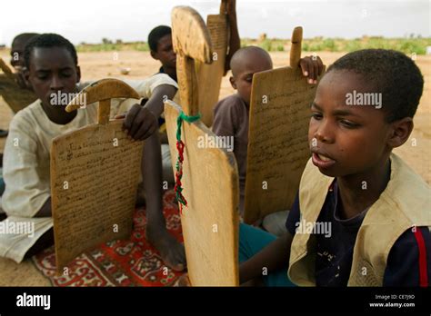 Sudanese Refugee Children In An Open Air School With Wood Notebooks