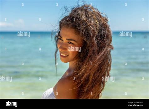 A Tropical Paradise With A Captivating Image Of A Woman Brimming With Joy In A Bikini As She