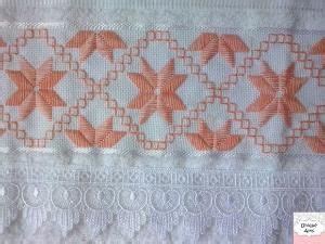 An Orange And White Lace With Flowers On It