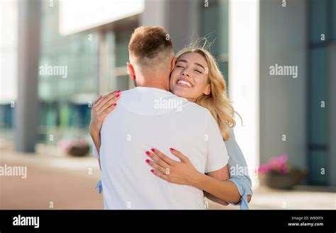 Couple Meeting After Long Time Hugging Near Airport Stock Photo Alamy