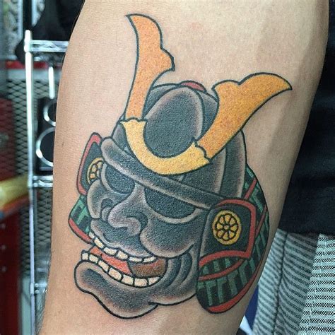 A Tattoo On The Leg Of A Person With A Helmet