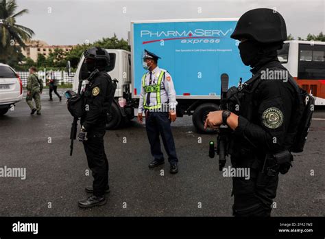 policemen stand guard  airport personnel transfer crates  mock