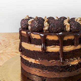 A Cake With Chocolate Frosting And Nuts On Top