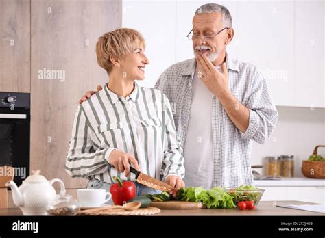 Mature deaf mute couple cooking in kitchen Stock Photo - Alamy