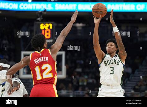 Milwaukee Bucks Marjon Beauchamp 3 Shoots For Three Points As He Is Guarded By Atlanta Hawks