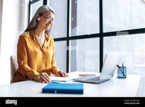 A Mature Satisfied Asian Gray Haired Business Woman Wearing Stylish