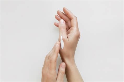 Premium Photo A Woman Applies A Cosmetic Cream On Her Hands Home Hand