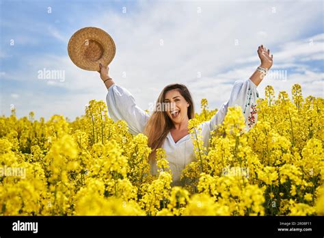 Portrait Of A Beautiful Blonde Hispanic Woman In A Blooming Canola Field Stock Photo Alamy