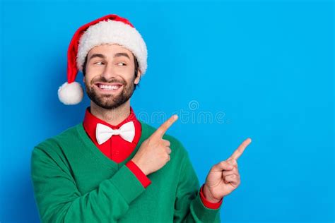 Photo Of Positive Handsome Guy Look Direct Fingers Empty Space X Mas Proposition Isolated On