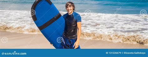 Man Carrying Surfboard Over His Head Close Up Of Handsome Guy With