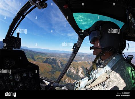 Cockpit view of a pilot of a Bell OH-58 Kiowa while flying above a deep ...