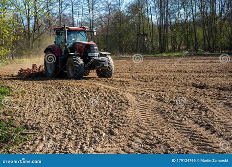 Farmer In Tractor Preparing Land With Seedbed Cultivator Morning Sun