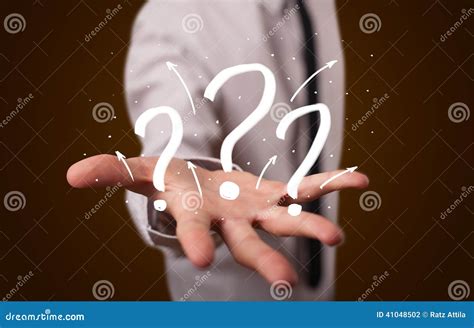 Young Businessman Presenting Hand Drawn Question Marks Stock Photo