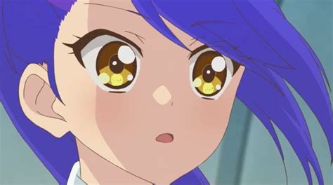 A Close Up Of A Person With Blue Hair And Yellow Eyes Looking At The Camera