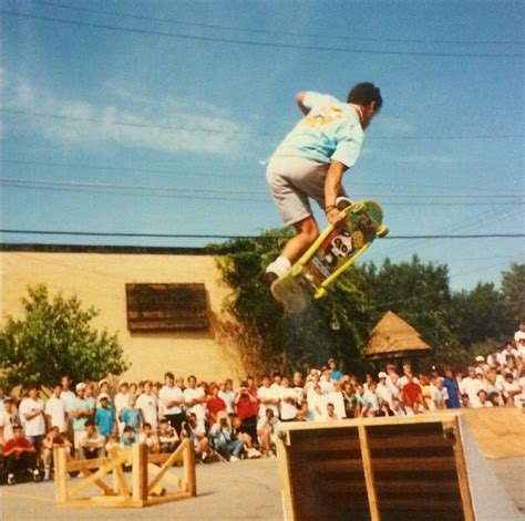 A Man Flying Through The Air While Riding A Skateboard In Front Of A Crowd