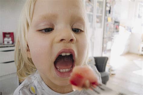 Portrait of blond little girl with open mouth stock photo