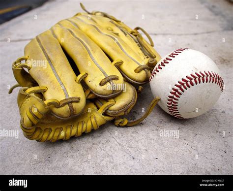 Photo of a baseball gloves and an old baseball Stock Photo - Alamy