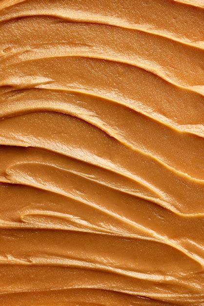 Premium Photo | Closeup of smooth peanut butter creamy goldenbrown ...