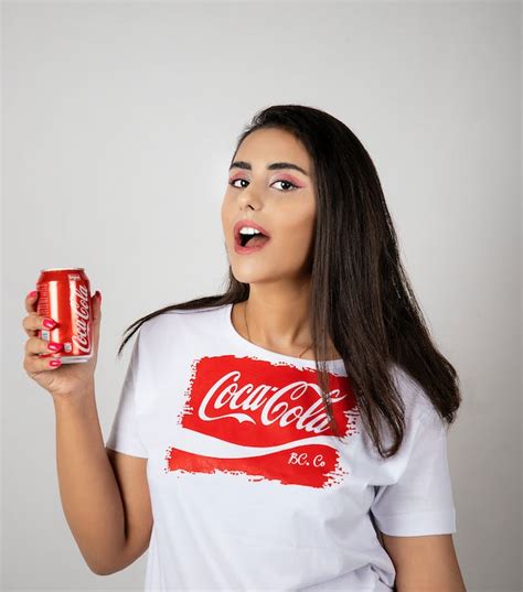 A Woman Holding A Coca Cola In Can · Free Stock Photo