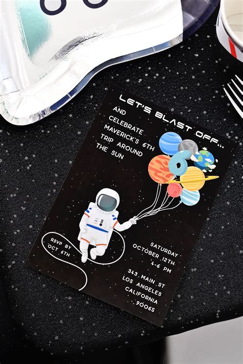 A Space Themed Birthday Party With Balloons Plates And Napkins On A