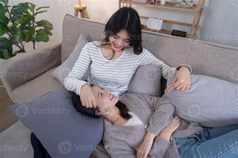 Cozy Lesbian Couple Relaxing At Home On A Comfortable Sofa Enjoying Quality Time Together In A