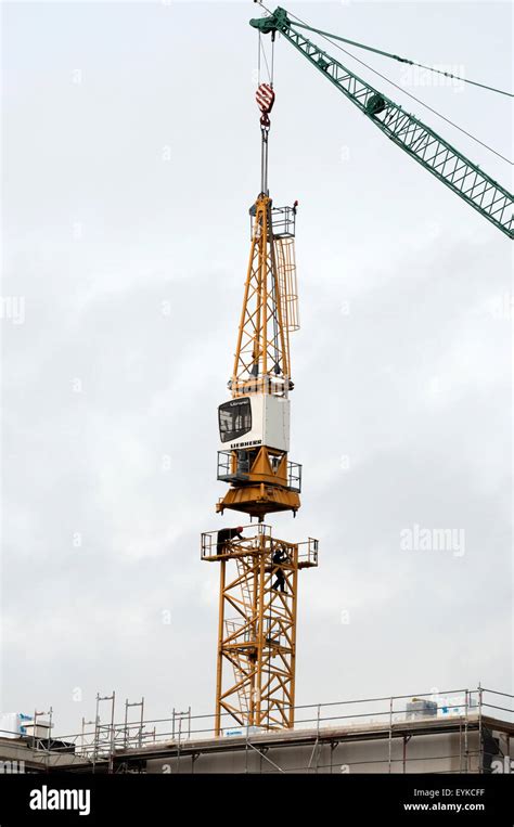 Construction Workers Dismantling Tower Crane Hi Res Stock Photography