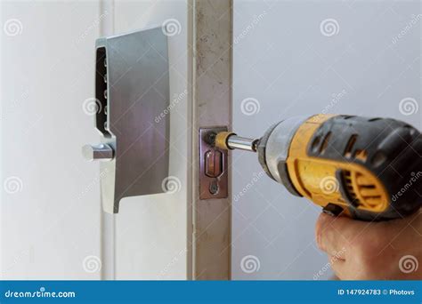 Rear View Of Repairman Installing Electronic Key Of The Door Lock Stock