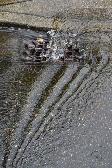 Heavy Rain Caused Flooding In Street, Water Swirling Around Storm Drain ...