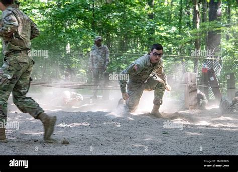 Cadets Emerge From The Dust After Completing The Low Wire Obstacle On