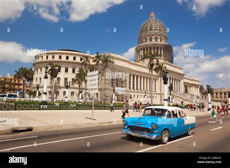 Vintage American Car In Front Of Capitolio Building In Center Havana