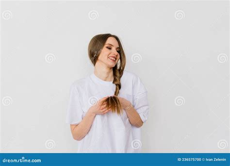 Girl Touching Her Hair And Smiling While Posing At Interior Looking In