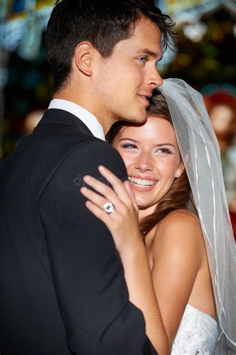 Shes Never Been Happier Shot Of A Happy Newlywed Couple Embracing In