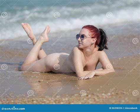 Naked Girl Lays On Wet Sand In Line Of Surf Stock Photo Image Of