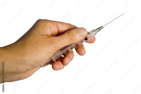 left hand holding  syringe   white background stock photo adobe