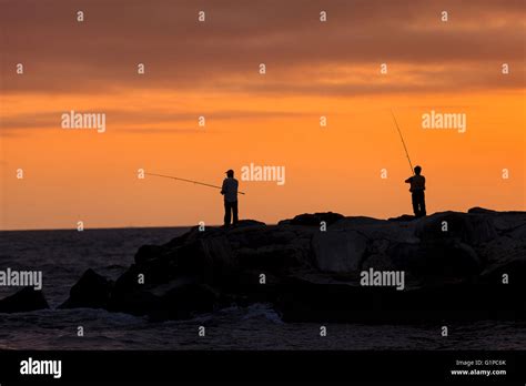 Silhouette Of Men Fishing On The Pier Off Balboa Island Newport Beach