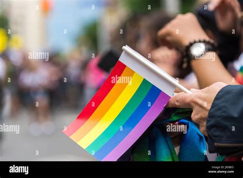 Gay Pride Parade Spectator Holding Small Gay Rainbow Flag During Toronto Pride Parade In