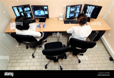 Radiology training. Radiology students examining MRI (magnetic ...