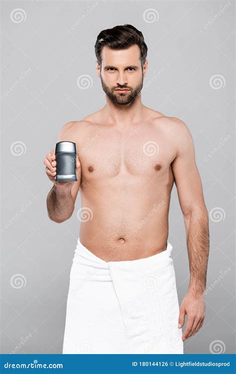 Bearded And Muscular Man In Towel Holding Deodorant Stock Photo Image