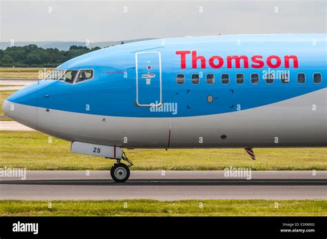 Side View Of The Front Of A Thomson Boeing 737 Plane As It Passes On A